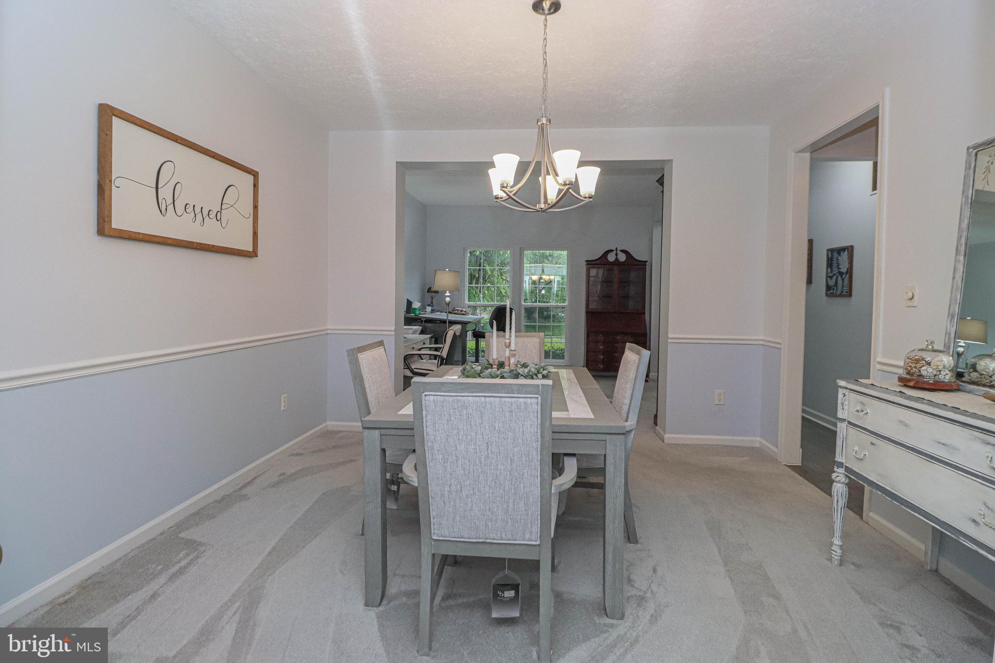 1724 Algonquin Road Frederick, MD 21701 - Photo 19 of 55 a view of a dining room with furniture a chandelier and wooden floor