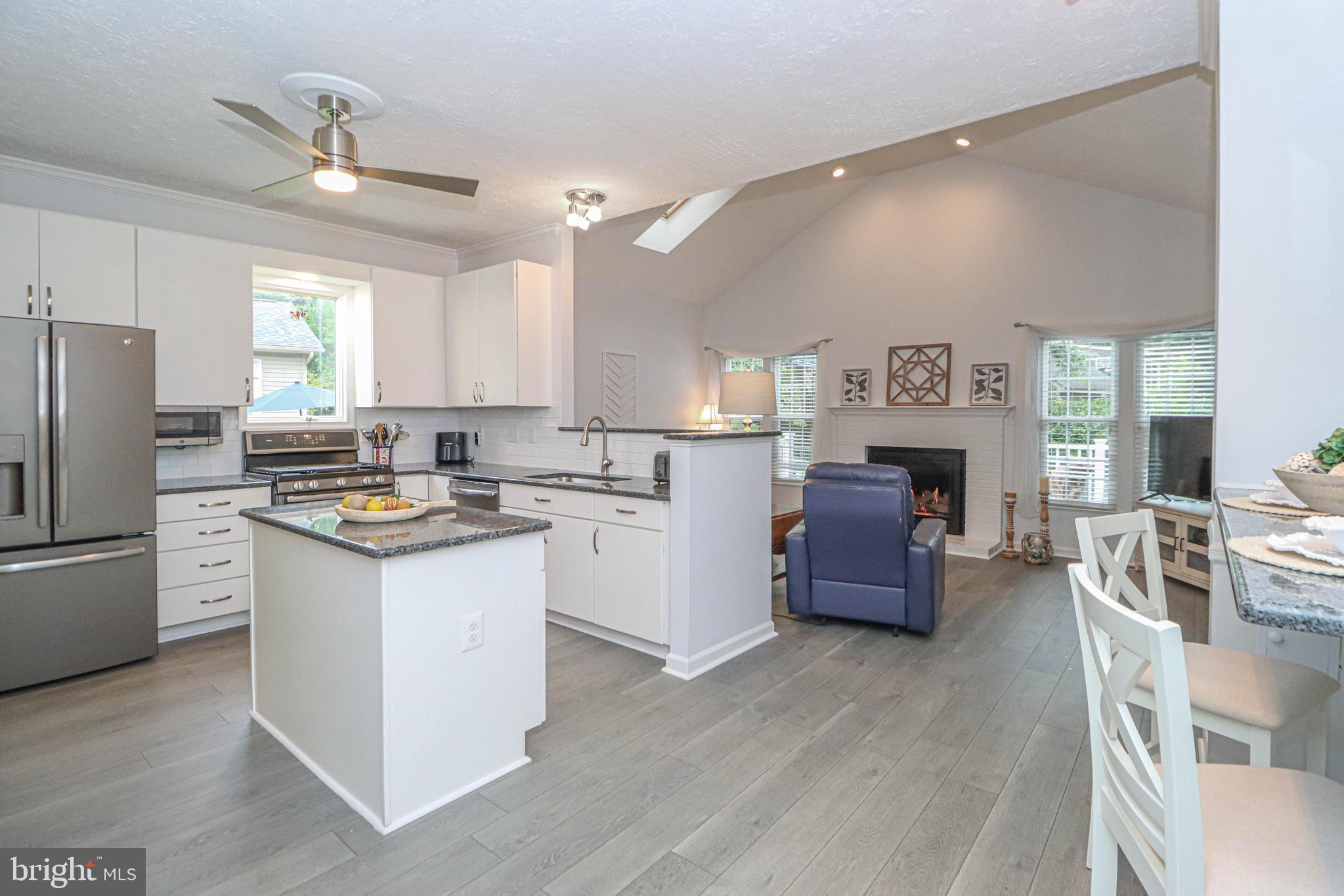 1724 Algonquin Road Frederick, MD 21701 - Photo 2 of 55 a kitchen with stainless steel appliances kitchen island granite countertop a refrigerator a stove a sink dishwasher a oven with white cabinets and wooden floor