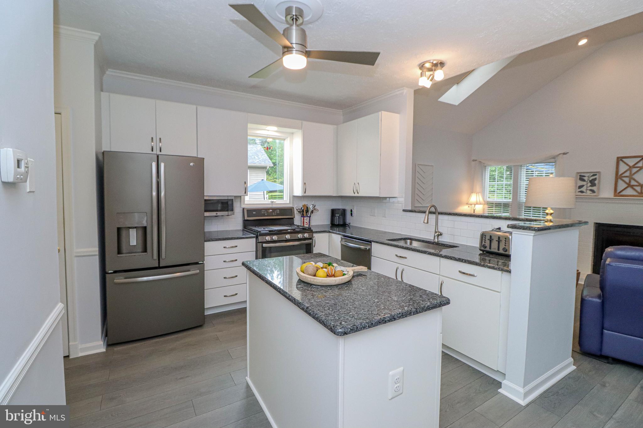 1724 Algonquin Road Frederick, MD 21701 - Photo 23 of 55 a kitchen with stainless steel appliances granite countertop a refrigerator a stove a sink a stove and island