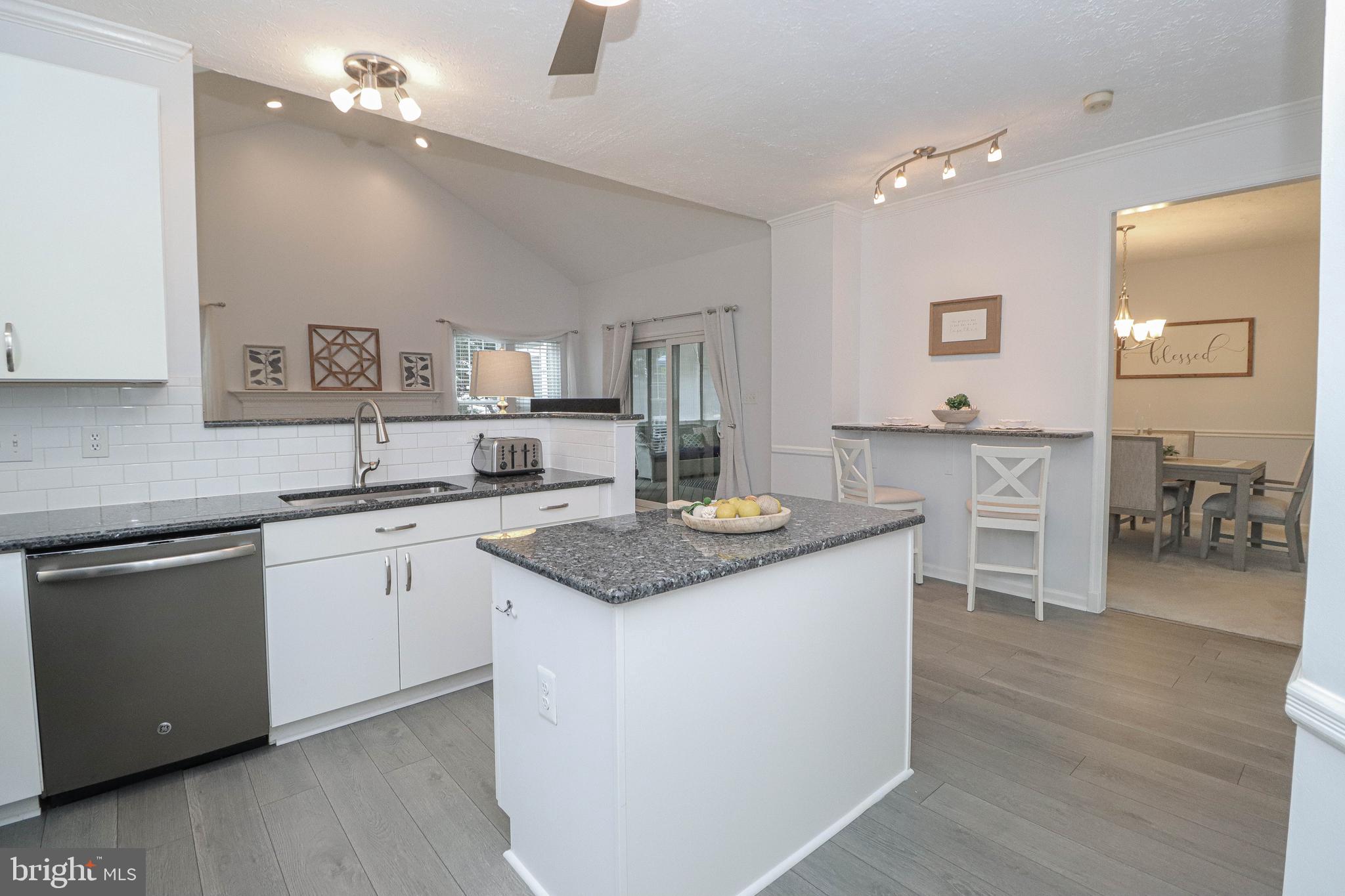 1724 Algonquin Road Frederick, MD 21701 - Photo 25 of 55 a kitchen with kitchen island granite countertop a sink cabinets and wooden floor
