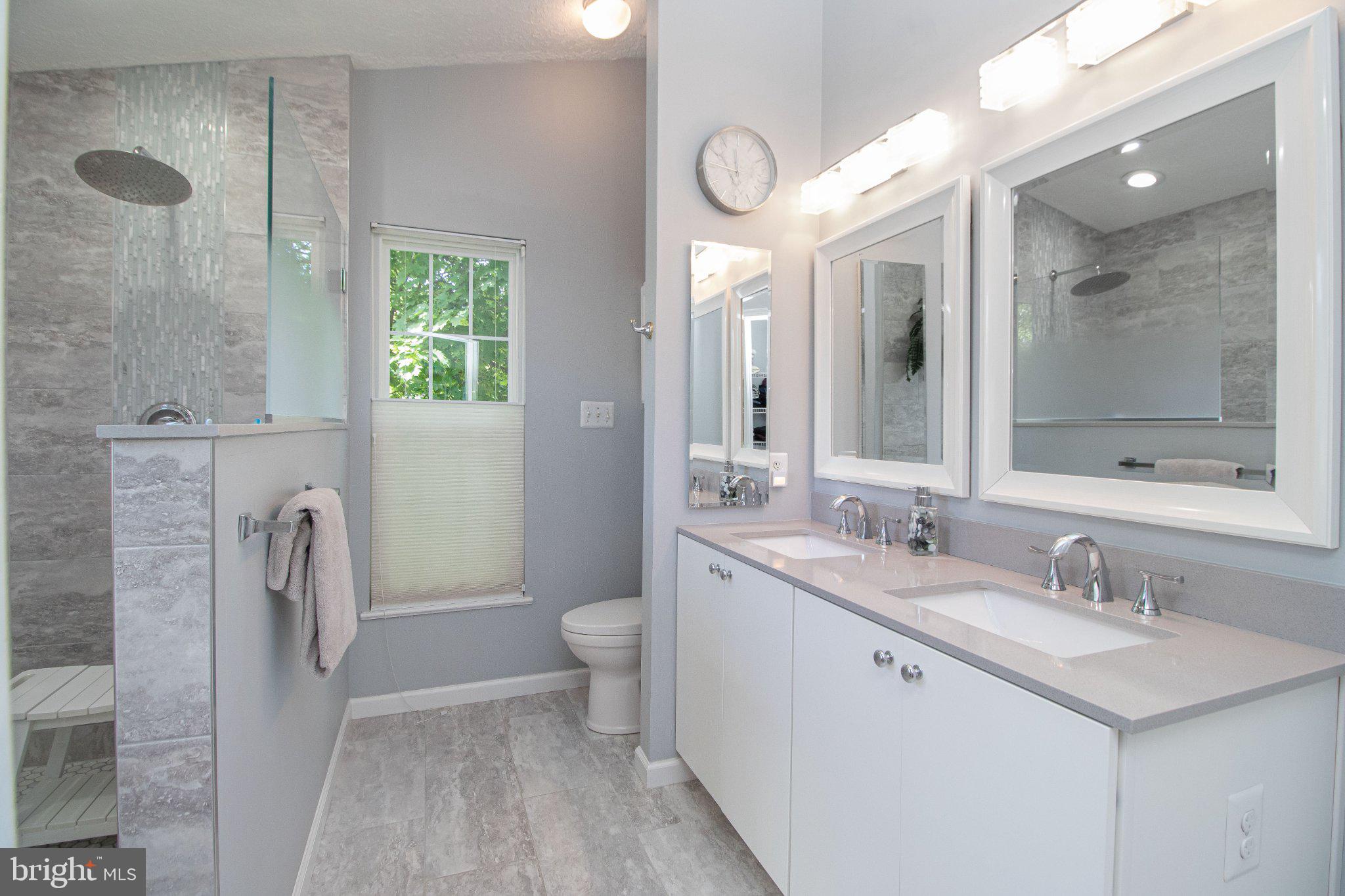 1724 Algonquin Road Frederick, MD 21701 - Photo 31 of 55 a bathroom with a double vanity sink toilet and shower