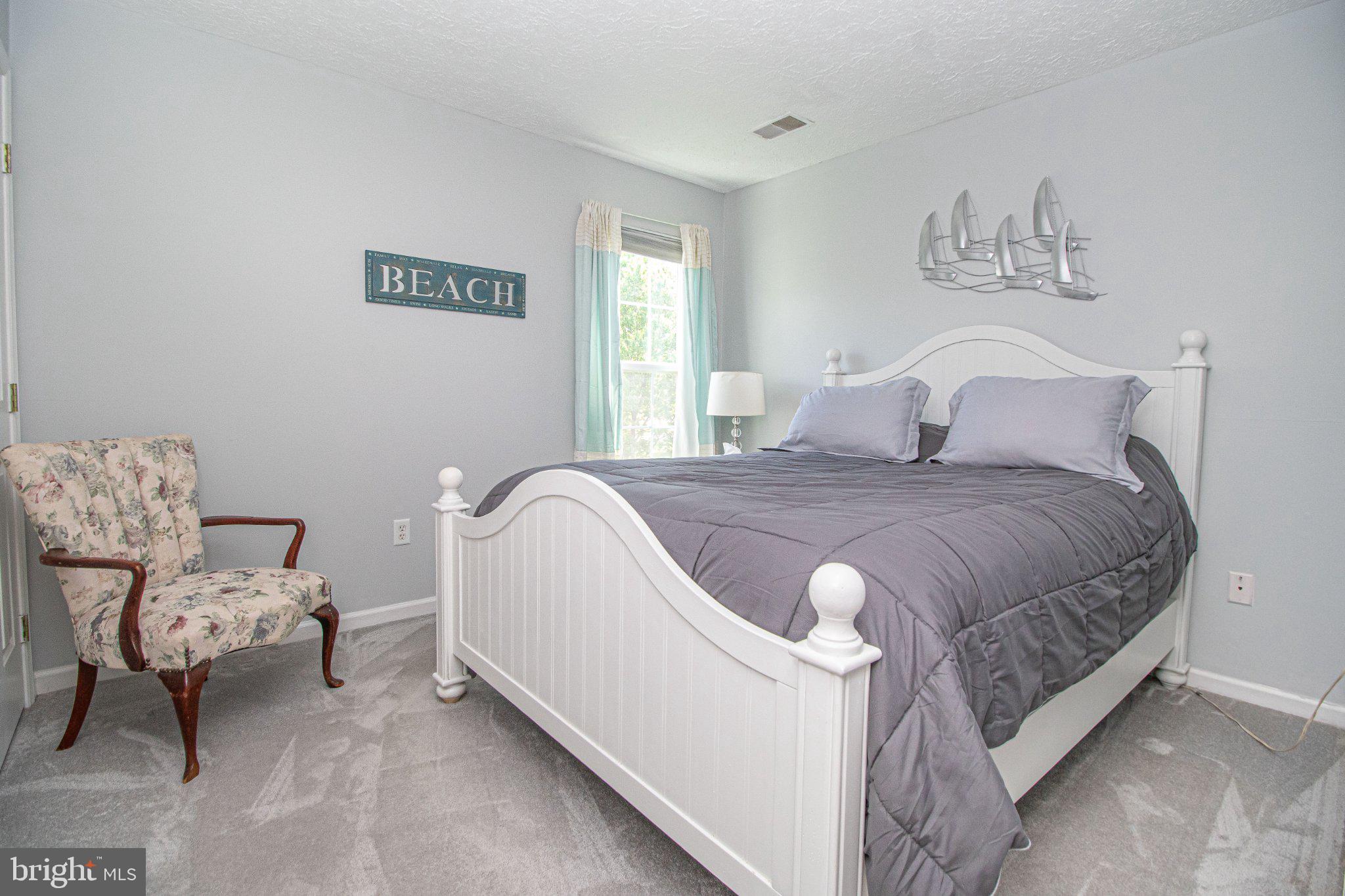 1724 Algonquin Road Frederick, MD 21701 - Photo 36 of 55 a spacious bedroom with a bed and chair