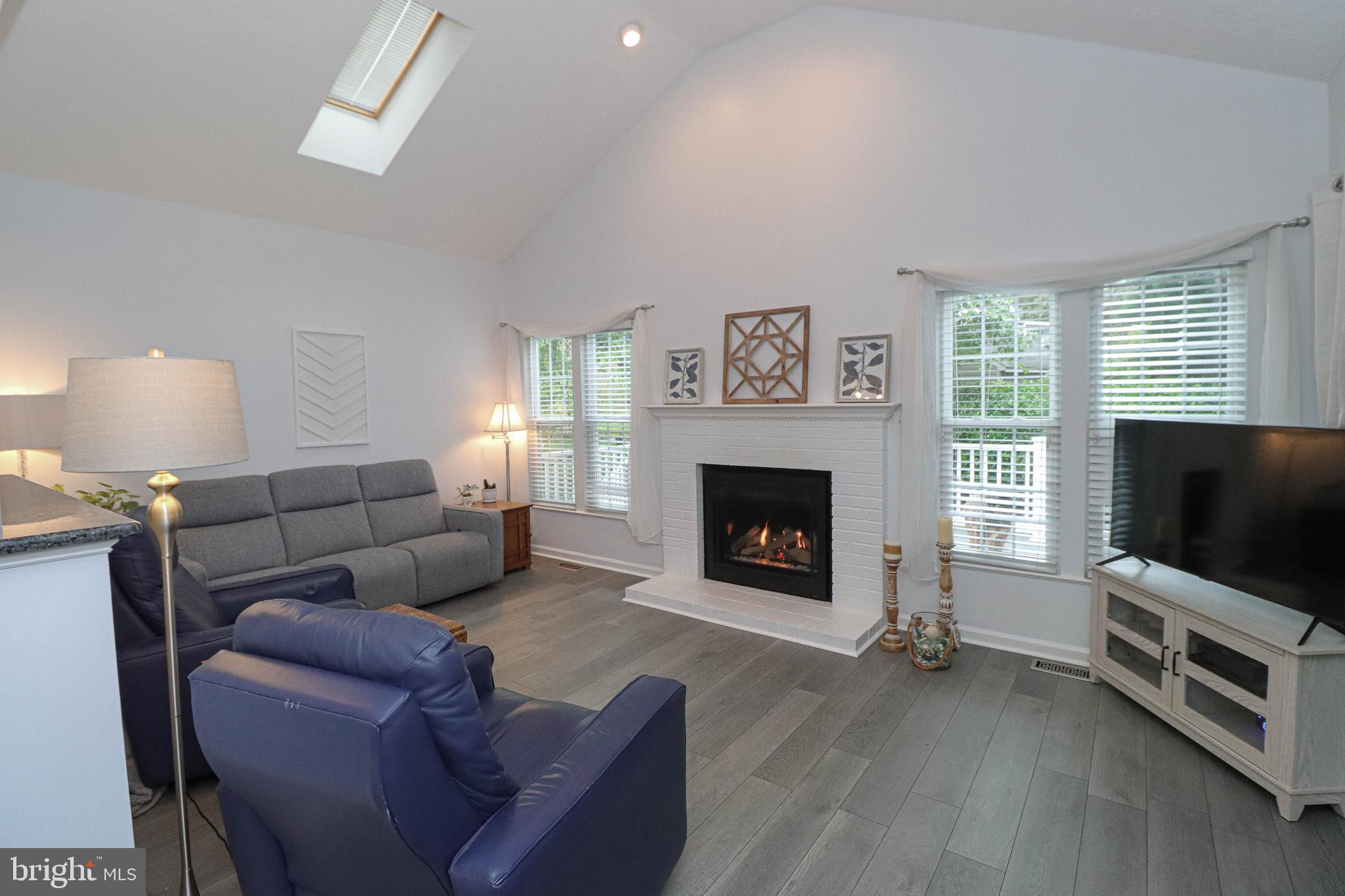 1724 Algonquin Road Frederick, MD 21701 - Photo 4 of 55 a living room with furniture a flat screen tv and a fireplace
