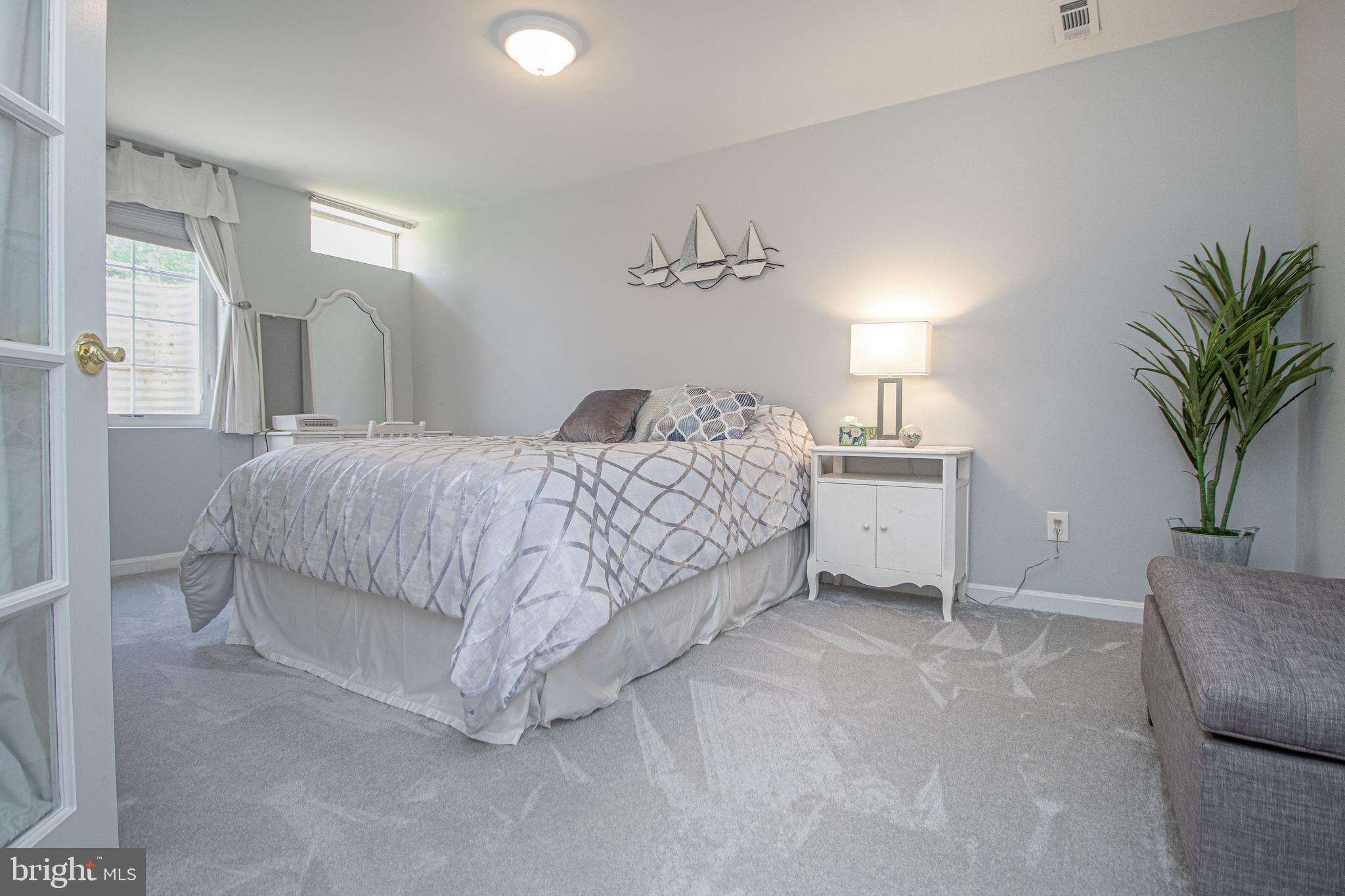 1724 Algonquin Road Frederick, MD 21701 - Photo 46 of 55 a bedroom with a bed and a potted plant