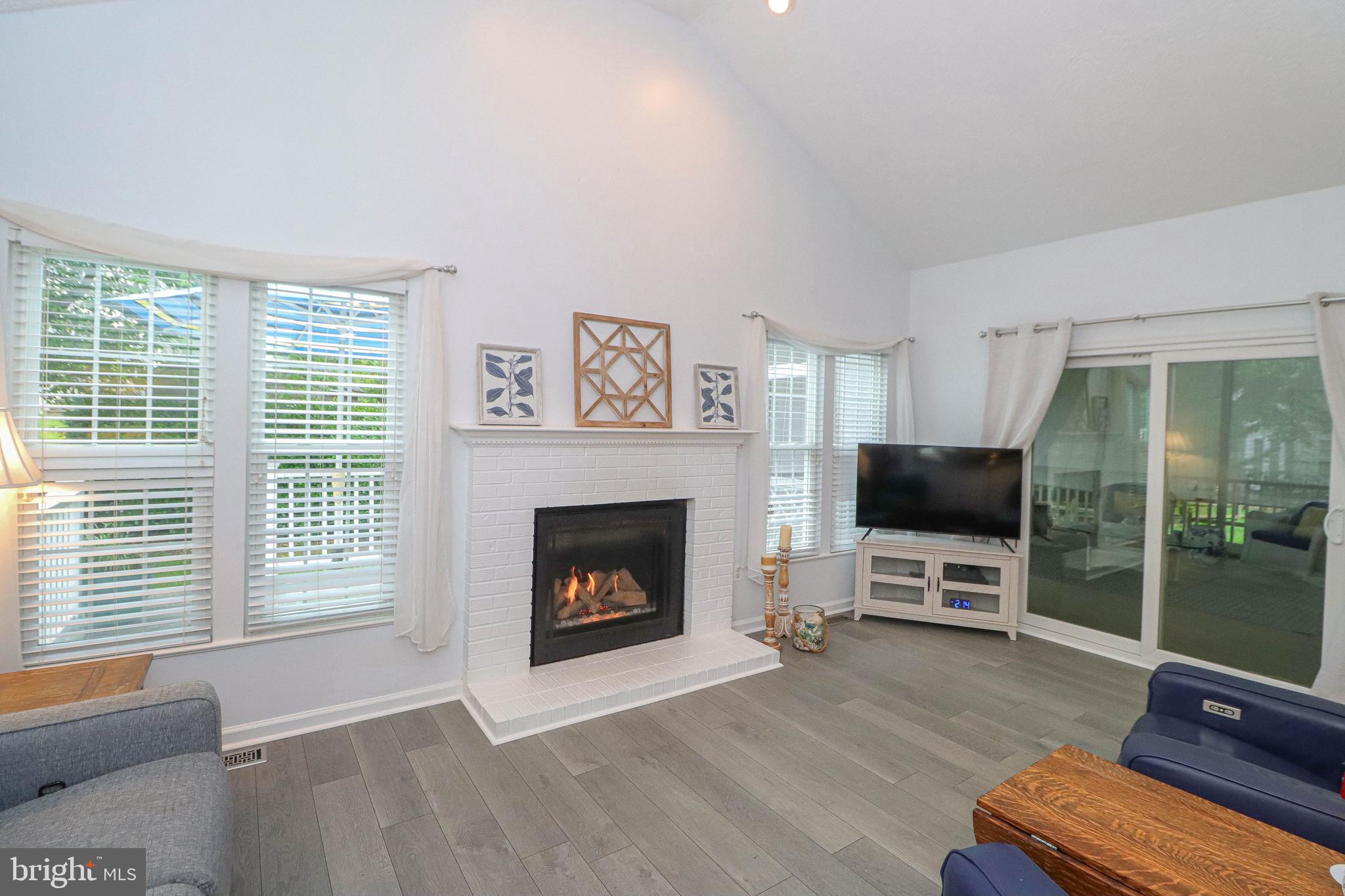 1724 Algonquin Road Frederick, MD 21701 - Photo 5 of 55 a living room with furniture a flat screen tv and a fireplace