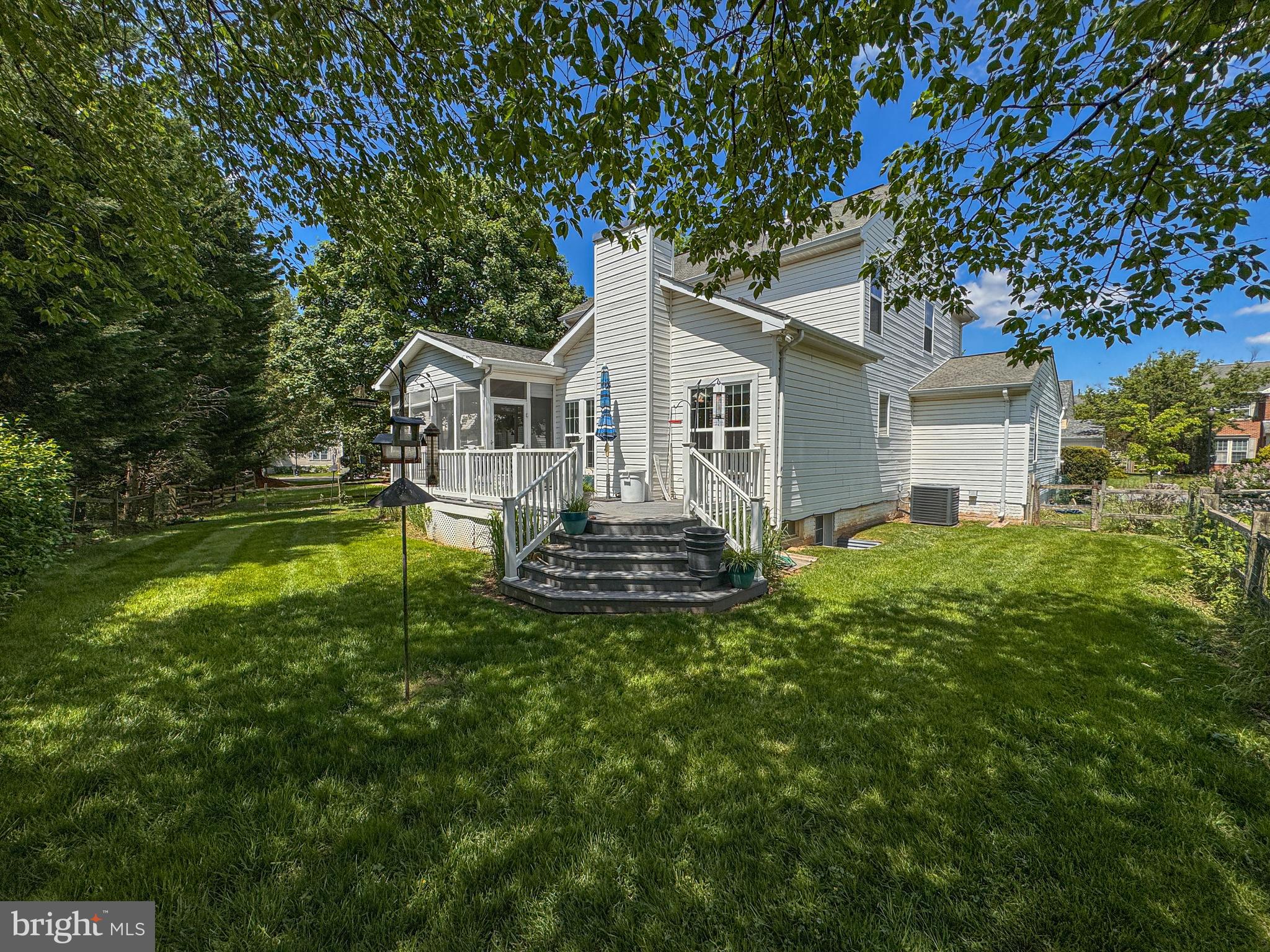 1724 Algonquin Road Frederick, MD 21701 - Photo 10 of 55 a front view of a house with a garden and trees