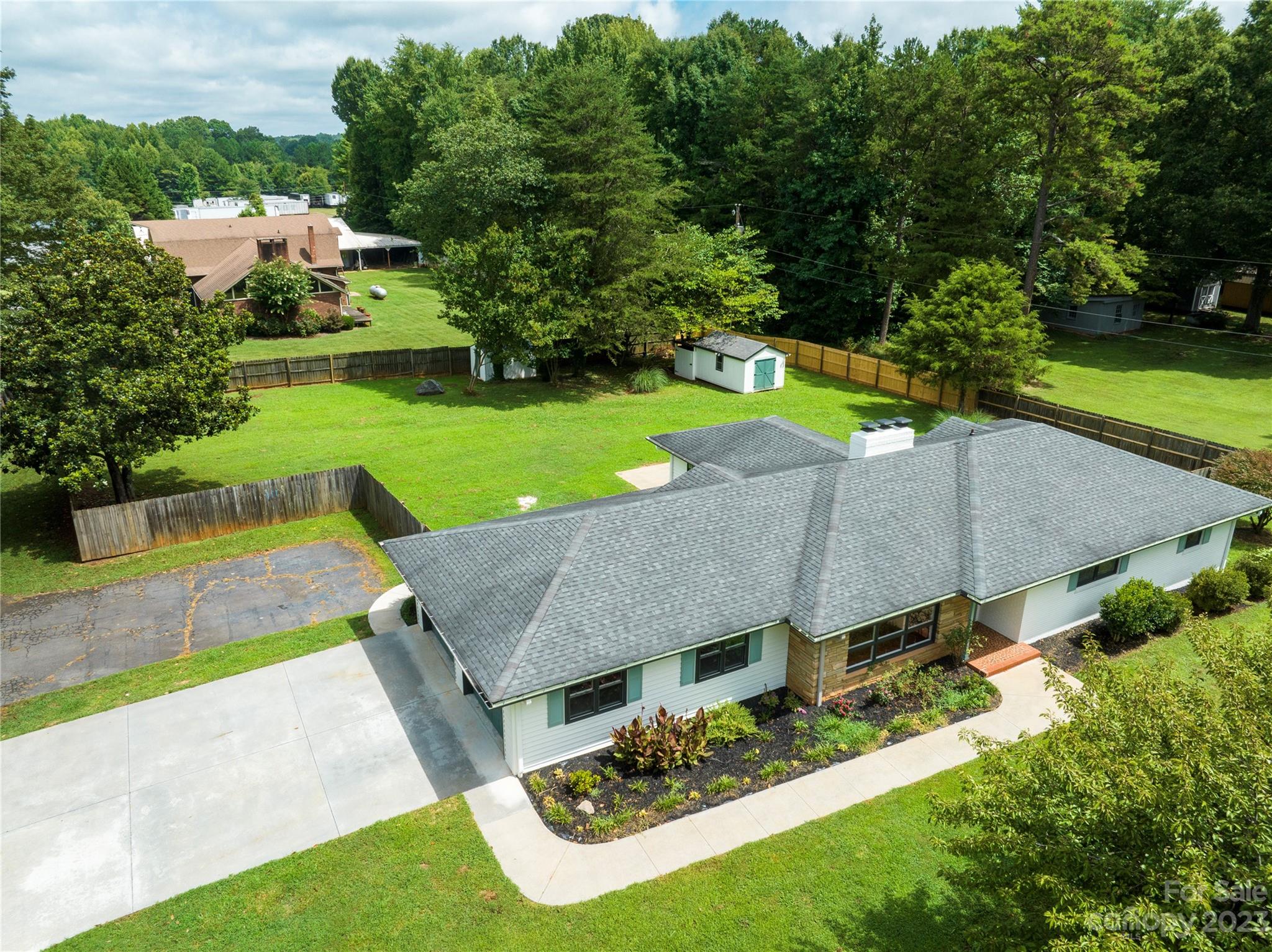 1253 Rainbow Road Advance, NC 27006 - Photo 1 of 46 an aerial view of a house with garden space and street view