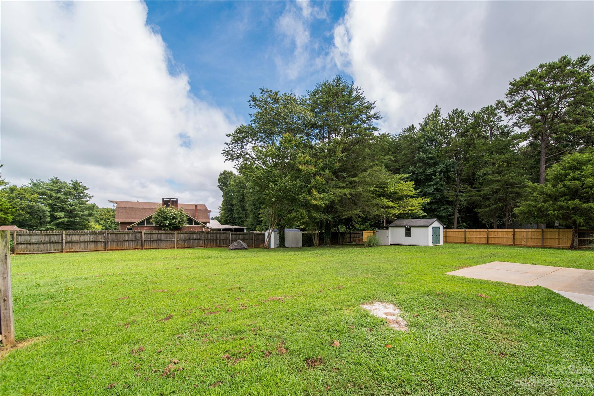 1253 Rainbow Road Advance, NC 27006 - Photo 14 of 46 a view of a big yard with a small yard and wooden fence