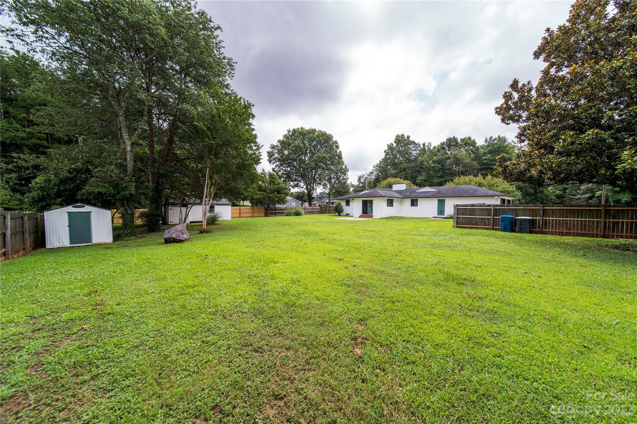 1253 Rainbow Road Advance, NC 27006 - Photo 19 of 46 a view of a house with a big yard and a large tree