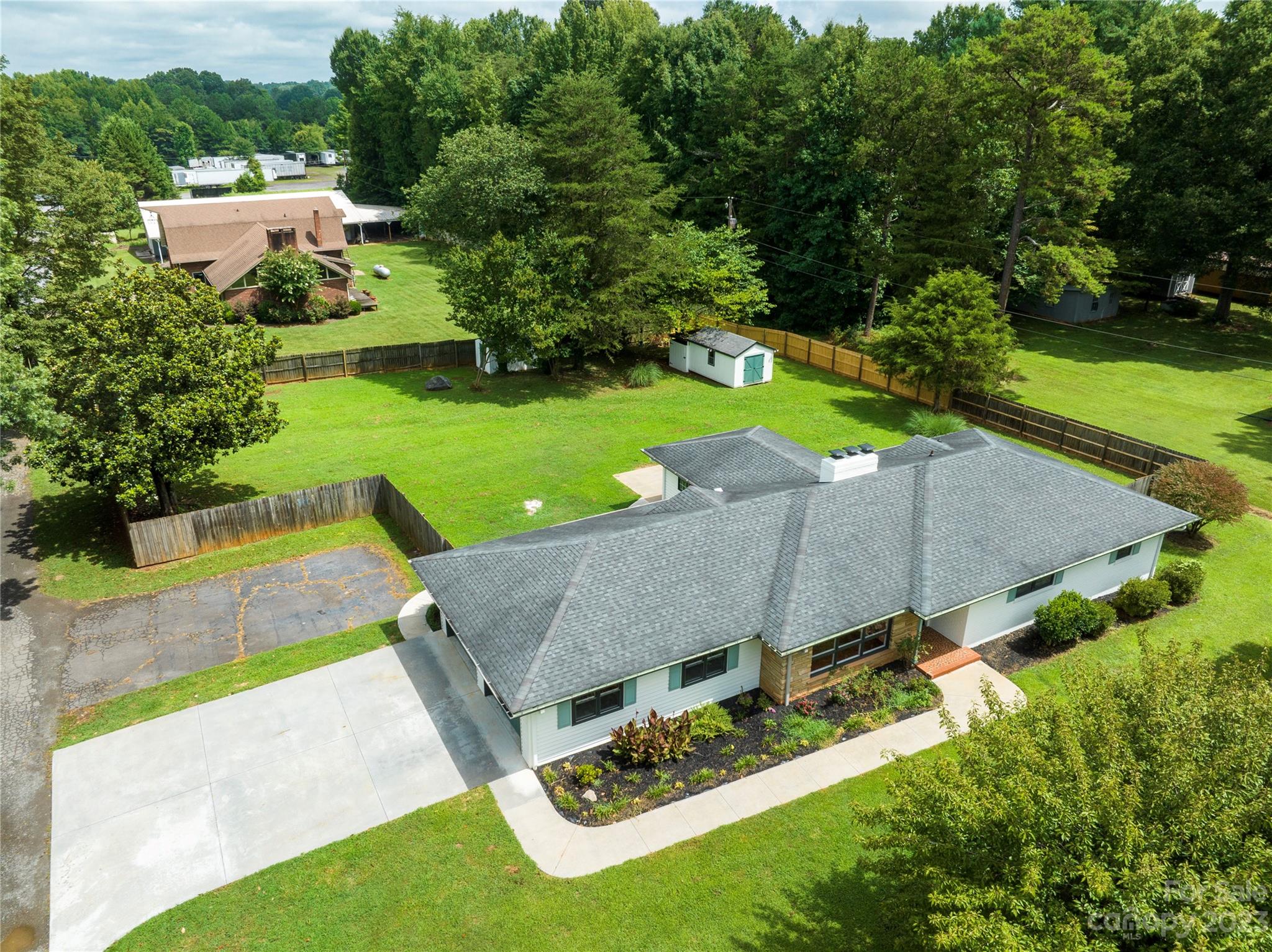1253 Rainbow Road Advance, NC 27006 - Photo 2 of 46 an aerial view of a house with pool big yard and large trees