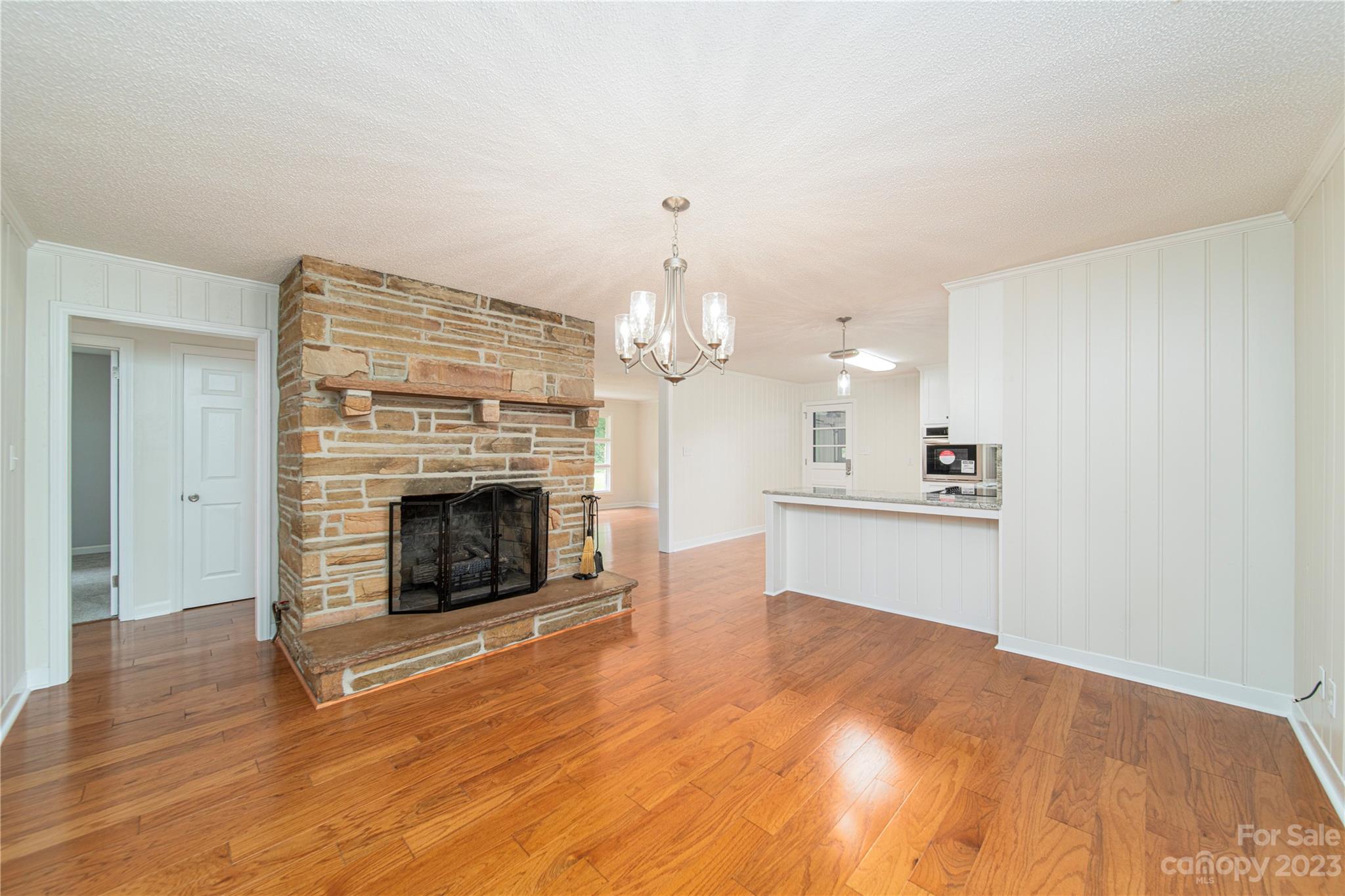 1253 Rainbow Road Advance, NC 27006 - Photo 26 of 46 a view of a kitchen with granite countertop fireplace and wooden floor