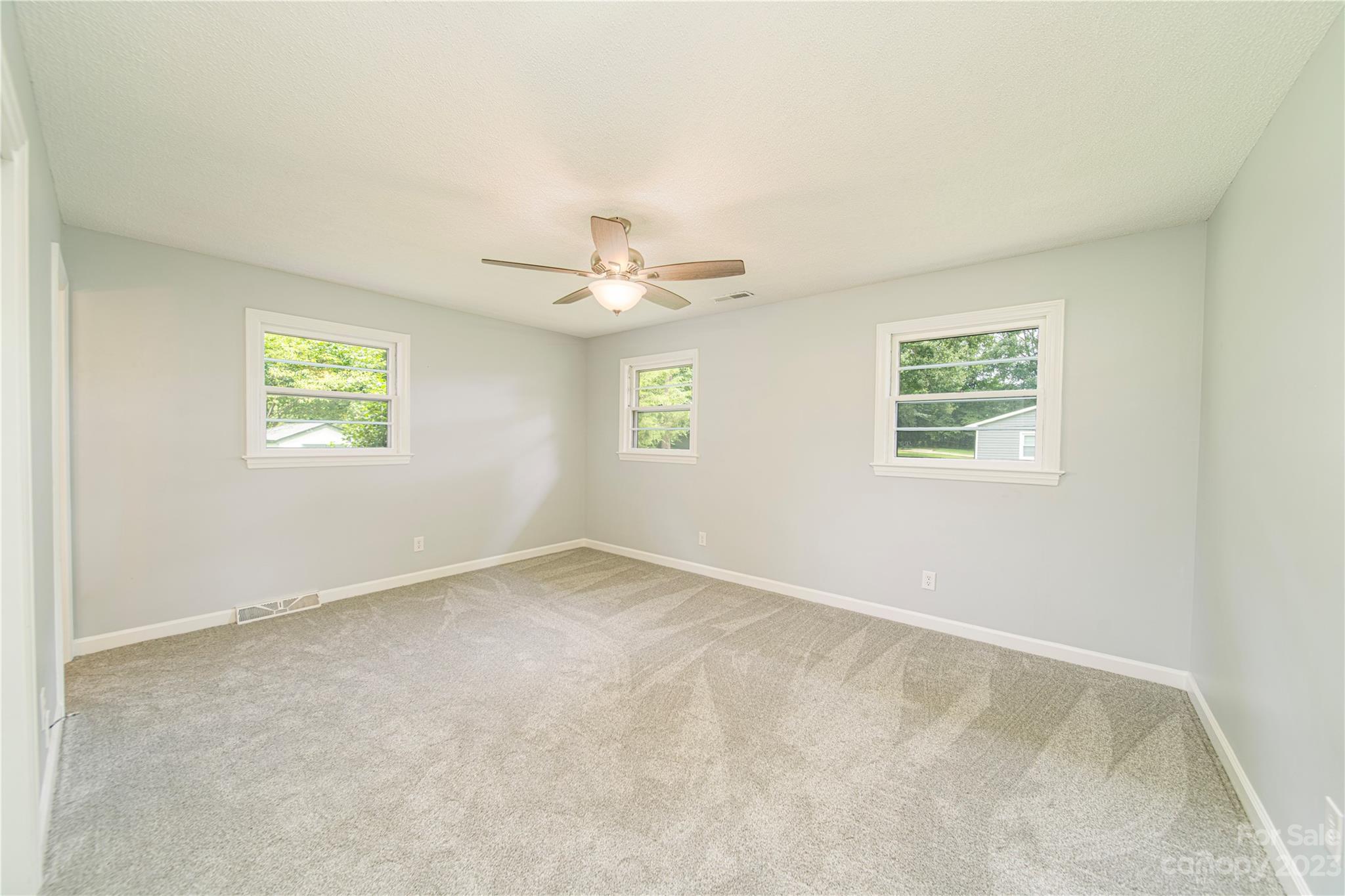 1253 Rainbow Road Advance, NC 27006 - Photo 32 of 46 an empty room with windows and fan