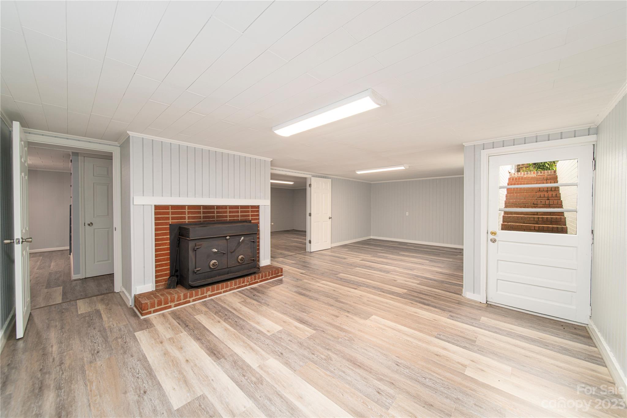 1253 Rainbow Road Advance, NC 27006 - Photo 42 of 46 a view of empty room with a fireplace and wooden floor