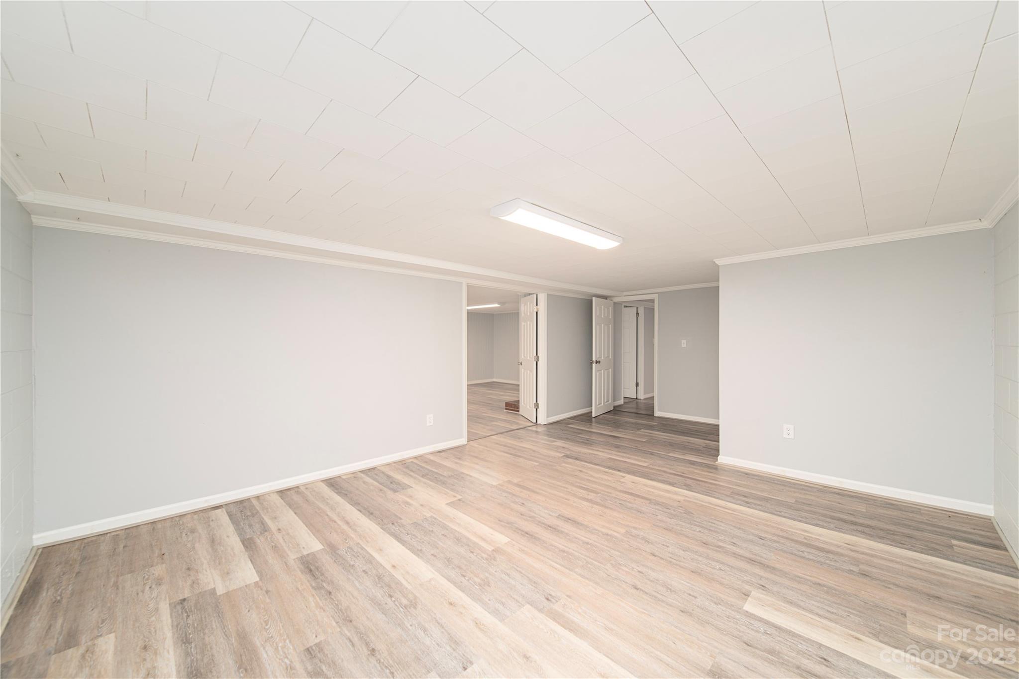 1253 Rainbow Road Advance, NC 27006 - Photo 46 of 46 a view of an empty room with wooden floor and a window