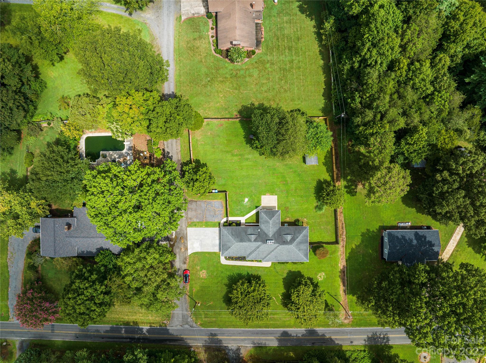 1253 Rainbow Road Advance, NC 27006 - Photo 5 of 46 an aerial view of a house with a yard lawn chairs and large tree