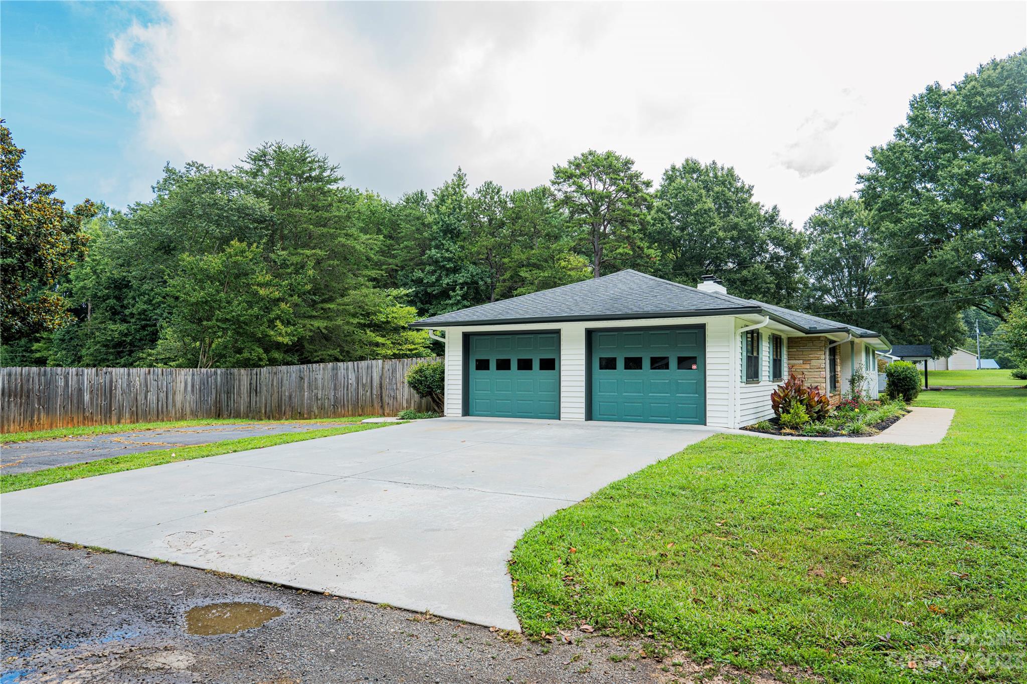 1253 Rainbow Road Advance, NC 27006 - Photo 10 of 46 a front view of a house with garden