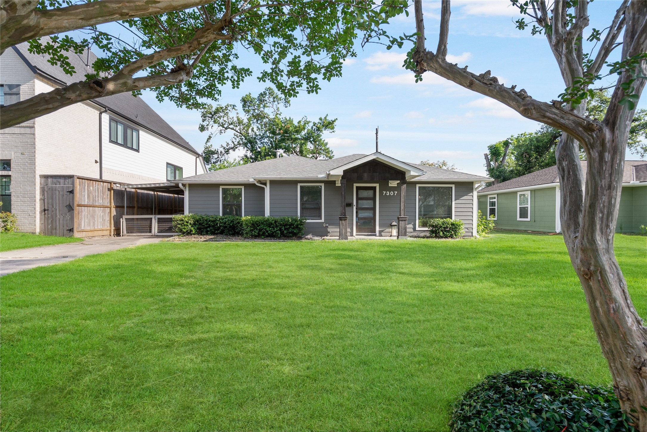 7307 Raton Street Houston, TX 77055 - Photo 2 of 23 This charming exterior welcomes you home each day! There is a long driveway with a gate to offer you plenty of parking space.