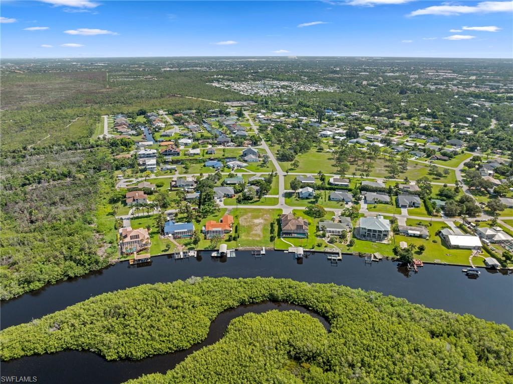 4947 Riverside Drive Estero, FL 33928 - Photo 14 of 16 an aerial view of residential houses with outdoor space and trees