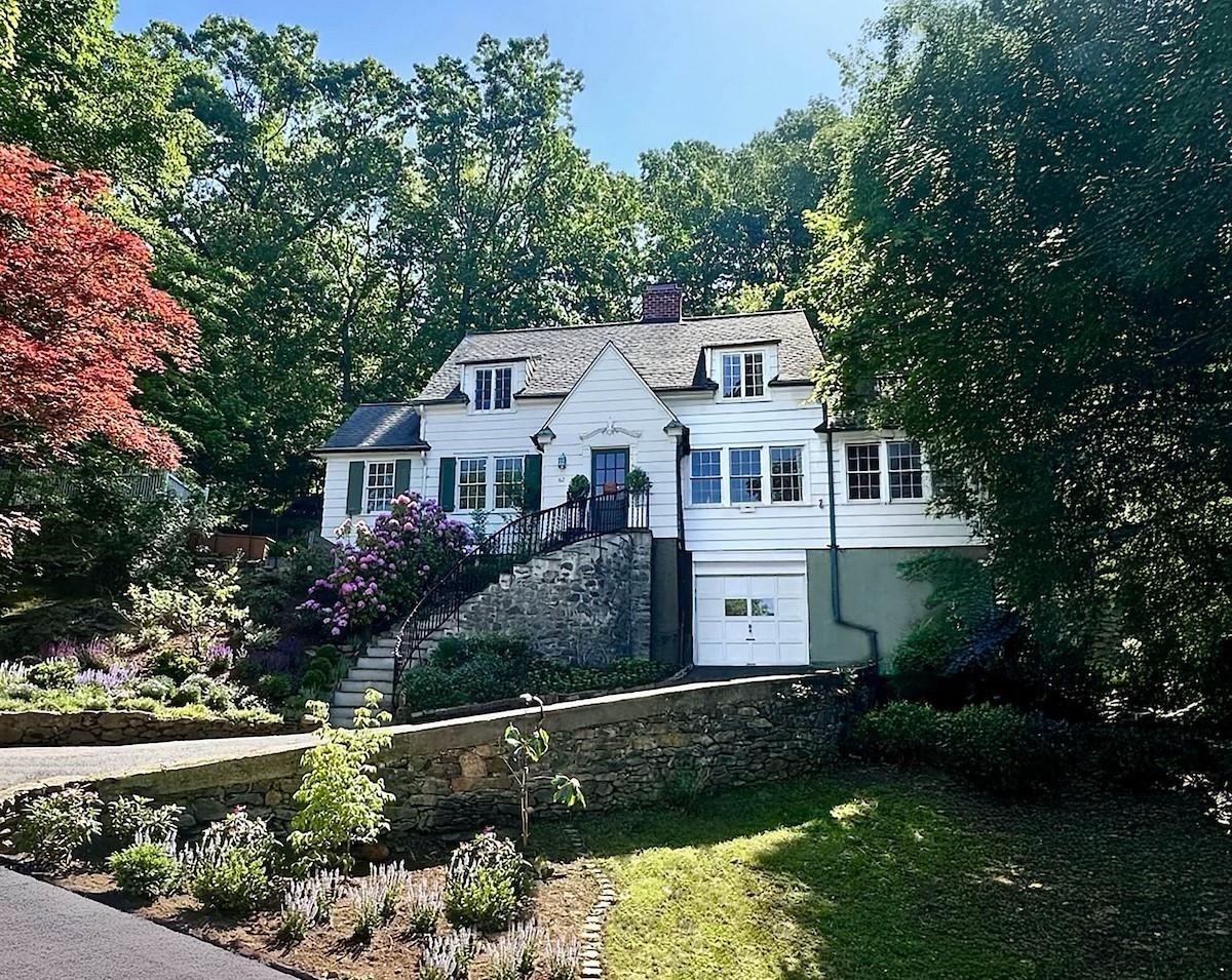 a front view of a house with a garden