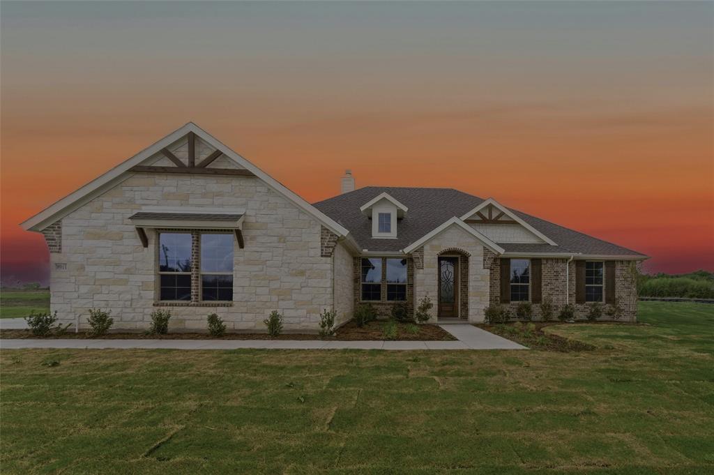 Craftsman house featuring stone siding, a lawn, and a chimney