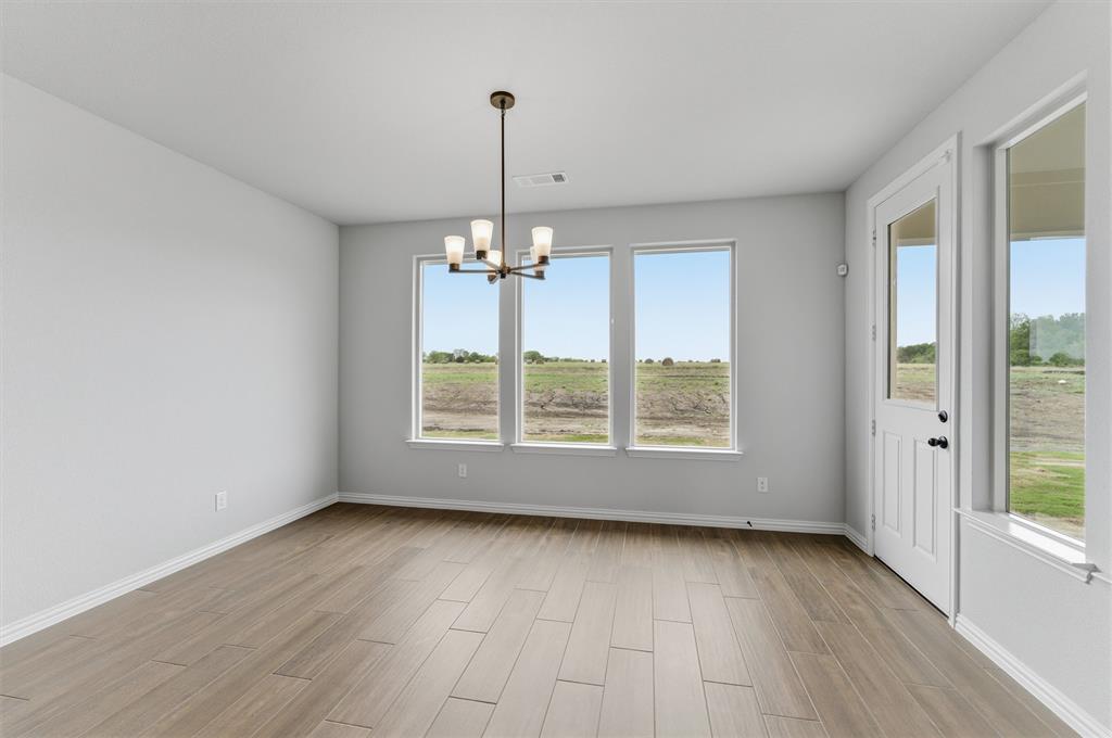 8911 County Road 623 Blue Ridge, TX 75424 - Photo 16 of 28 Unfurnished dining area featuring a chandelier and wood tiled floors