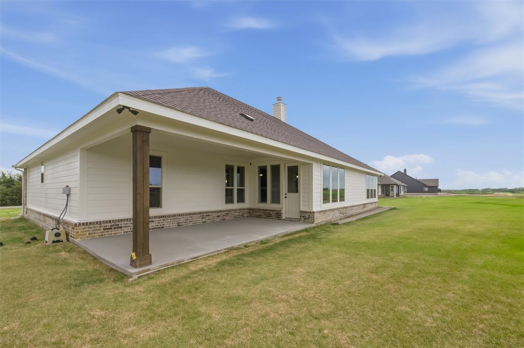 8911 County Road 623 Blue Ridge, TX 75424 - Photo 26 of 28 Rear view of house with a lawn, brick siding, a patio area, a chimney, and a shingled roof