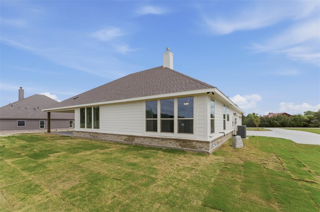 8911 County Road 623 Blue Ridge, TX 75424 - Photo 28 of 28 Back of property with a yard, a chimney, brick siding, and roof with shingles