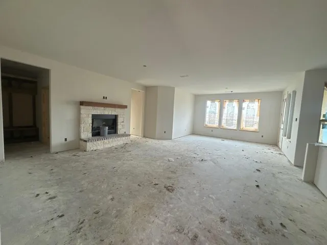a view of empty room with a fireplace