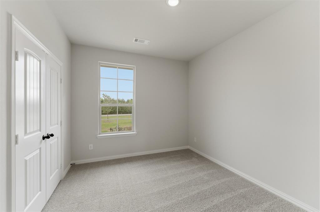 8911 County Road 623 Blue Ridge, TX 75424 - Photo 7 of 28 Unfurnished bedroom featuring light carpet and a closet