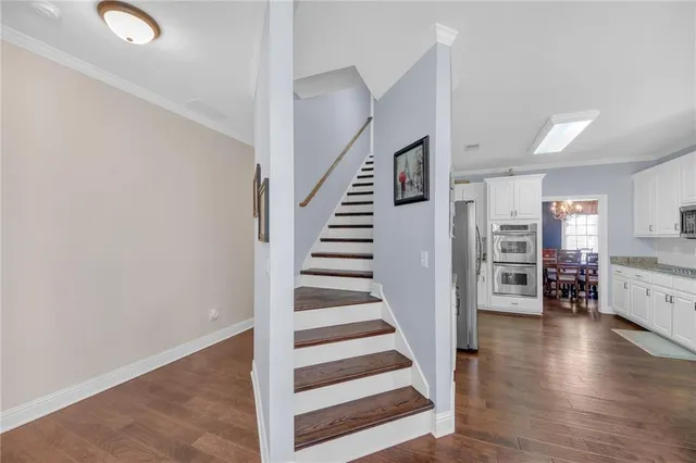 a view of a livingroom with hardwood floor and stairs