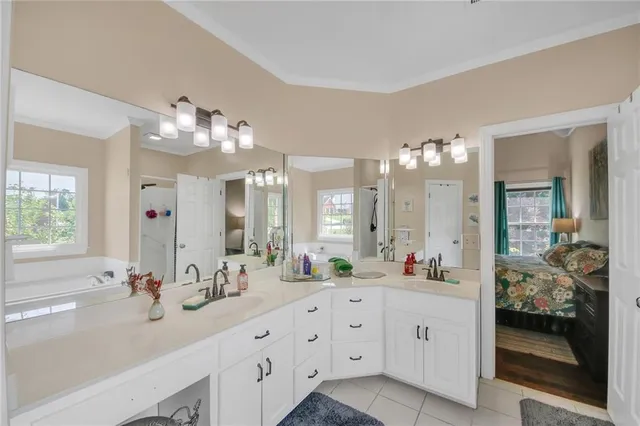 a bathroom with a double vanity sink mirror and shower
