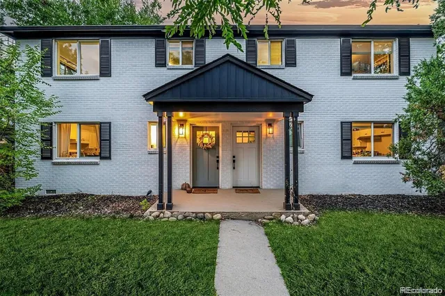 a front view of a house with garden