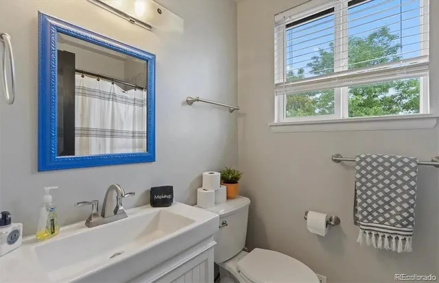 a bathroom with a sink a mirror and a toilet