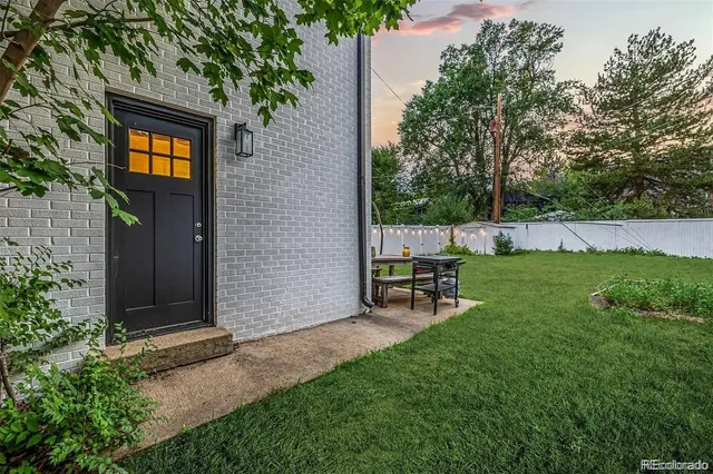 a view of a outdoor space with a garden and sitting area