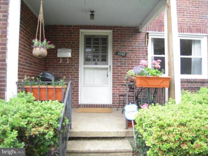 3702 Kimble Road Baltimore, MD 21218 - Photo 1 of 10 a front view of a house with a garden