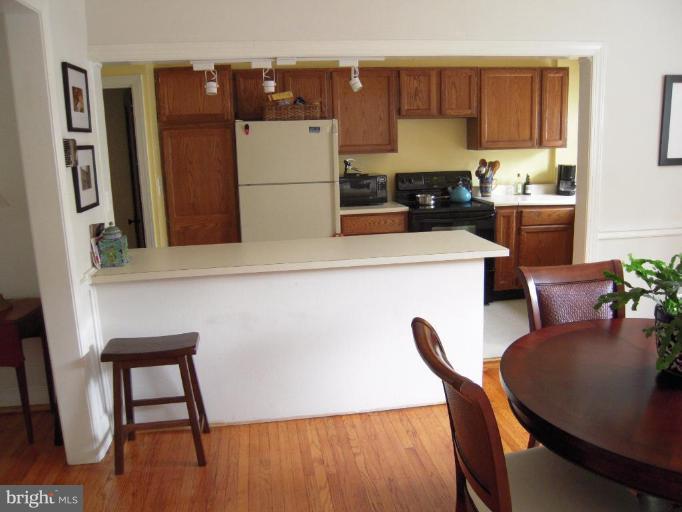 3702 Kimble Road Baltimore, MD 21218 - Photo 6 of 10 a kitchen with a table chairs and a refrigerator