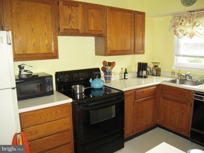 3702 Kimble Road Baltimore, MD 21218 - Photo 8 of 10 a kitchen with sink cabinets and stove top oven