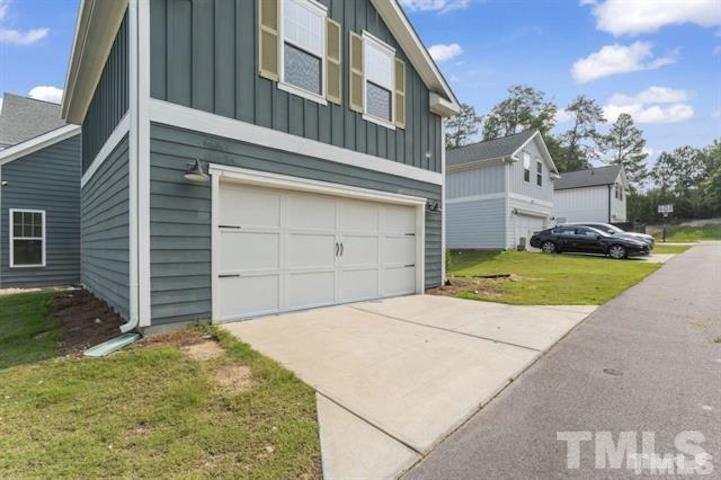 3116 Thurman Dairy Loop Wake Forest, NC 27587 - Photo 2 of 2 a view of a house with a backyard and a garage