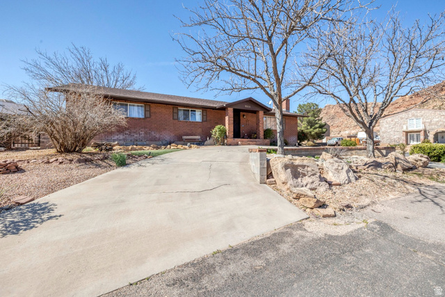 3334 Ute Road St. George, UT 84790 - Photo 39 of 40 View of front facade with brick siding and a chimney