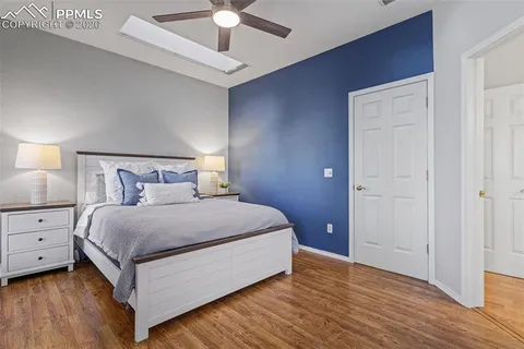 a bedroom with a bed and a ceiling fan