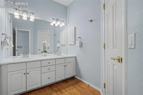 a bathroom with a granite countertop sink a mirror and a shower