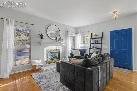 a living room with furniture a fireplace and a window