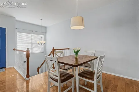 a view of a dining room with furniture and a window