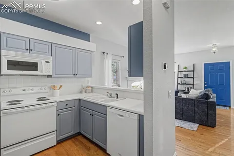 a kitchen with a sink stove and cabinets