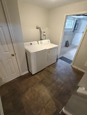 a utility room with a sink a washer and dryer
