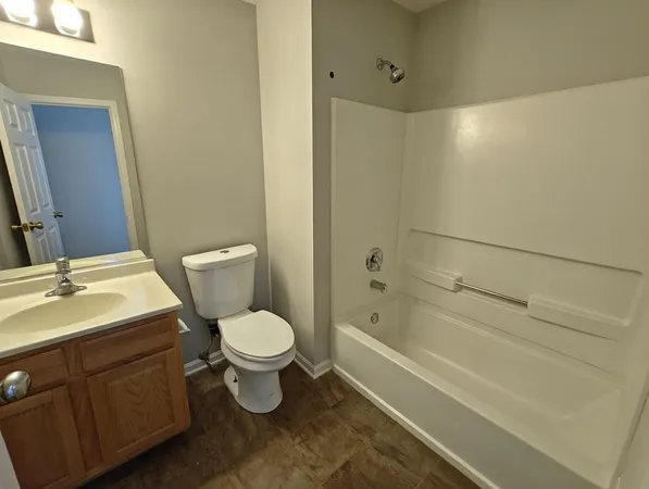 a bathroom with a toilet sink and shower