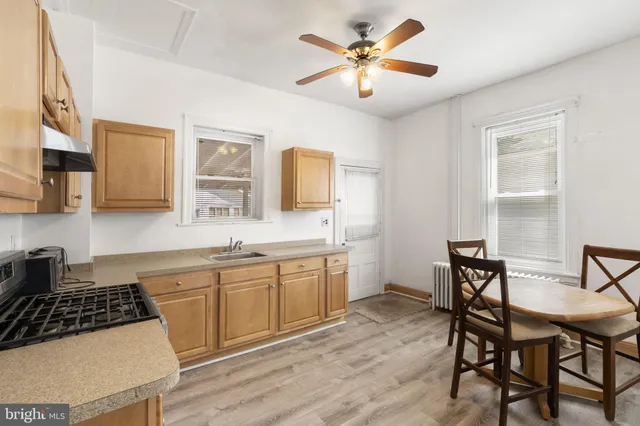 a kitchen with a table chairs stove and cabinets