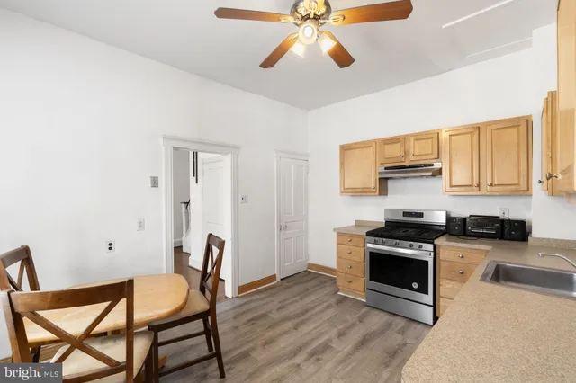 a kitchen with stainless steel appliances a stove a sink and a refrigerator