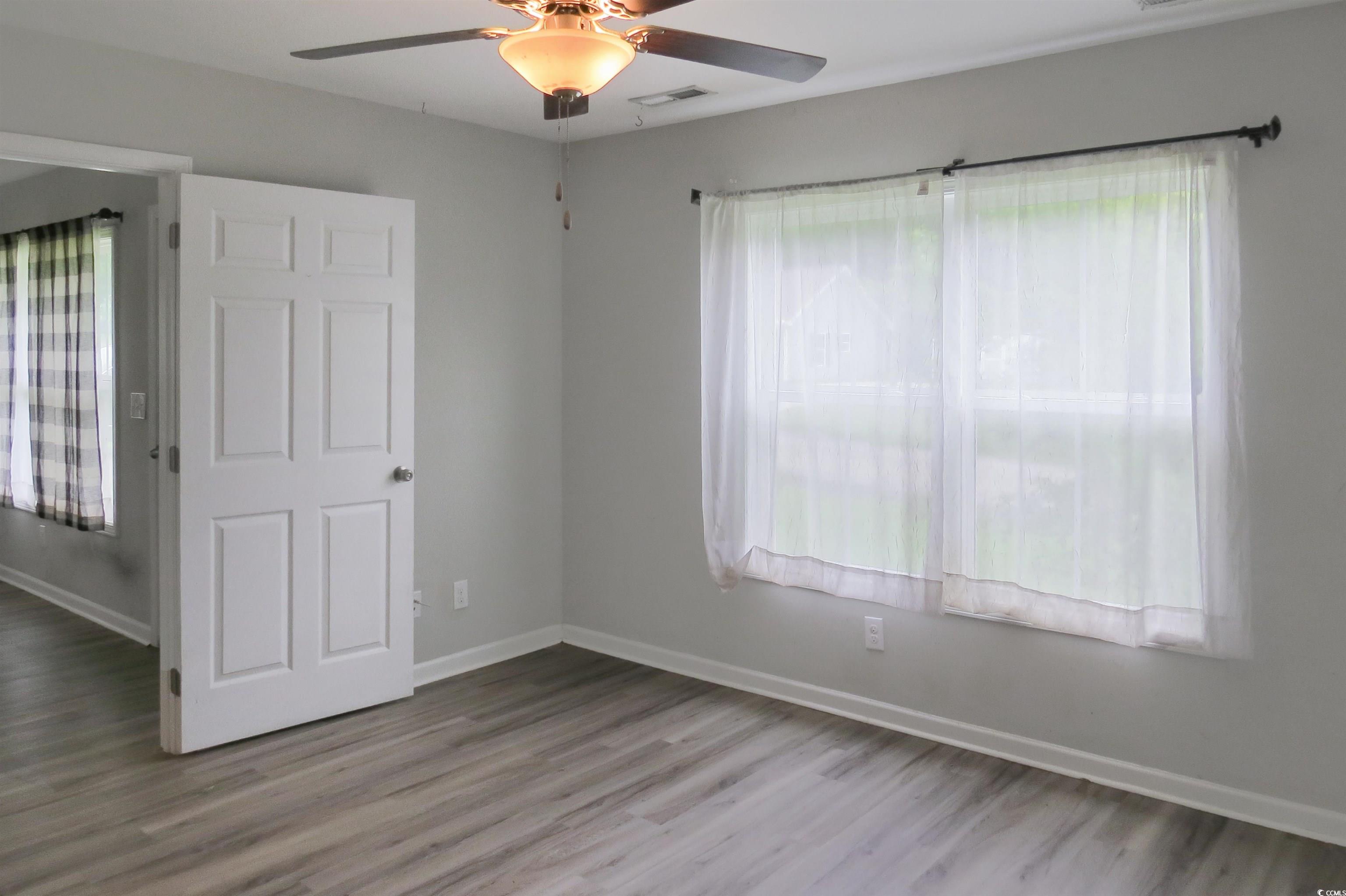 204 Rosedale Drive Aynor, SC 29511 - Photo 11 of 23 Primary bedroom with plenty of natural light, wood finished floors, and ceiling fan