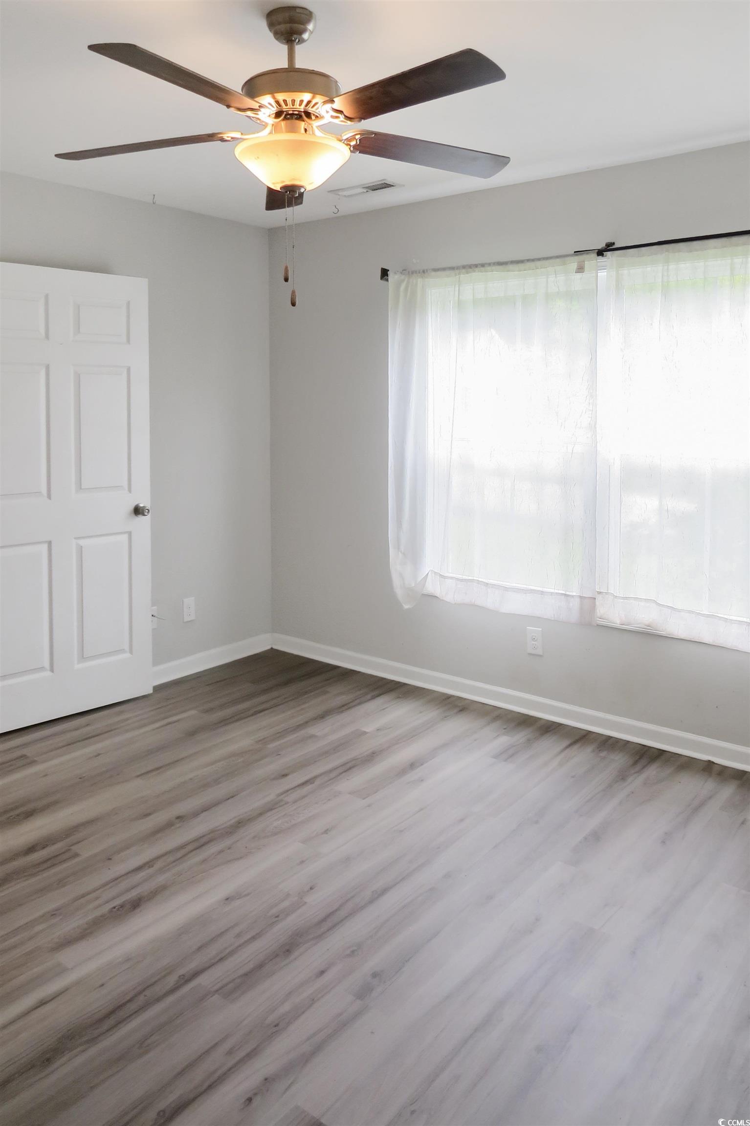 204 Rosedale Drive Aynor, SC 29511 - Photo 16 of 23 Primary bedroom featuring wood finished floors and a ceiling fan